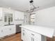 Modern kitchen with white cabinets, quartz countertops, and stainless steel appliances at 8731 Raleigh, Benson, NC 27504