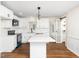 Modern kitchen with white cabinets, quartz countertops, and stainless steel appliances at 8731 Raleigh, Benson, NC 27504