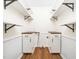 A utility room with white cabinets, wood countertop and open shelving on the top at 8731 Raleigh, Benson, NC 27504