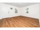 Bright living room with a front door, multiple windows providing natural light and wood floors at 8731 Raleigh, Benson, NC 27504