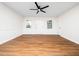 Well-lit living room featuring hardwood floors and a modern ceiling fan at 8731 Raleigh, Benson, NC 27504