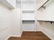 Walk-in closet with wood floor and built-in shelves that maximize storage and organization at 8731 Raleigh, Benson, NC 27504