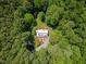 Aerial view of a secluded home surrounded by lush trees, offering privacy and tranquility at 9625 Collins Creek Dr, Chapel Hill, NC 27516