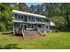 Relaxing view of a backyard patio and deck with outdoor seating and a grill area at 9625 Collins Creek Dr, Chapel Hill, NC 27516
