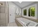 Bright bathroom featuring a soaking tub, separate shower, and natural light at 9625 Collins Creek Dr, Chapel Hill, NC 27516