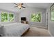 Bright bedroom with large windows providing scenic views and natural light at 9625 Collins Creek Dr, Chapel Hill, NC 27516