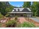 Charming two-story home features a long front porch, brick walkway, and beautifully landscaped front yard at 9625 Collins Creek Dr, Chapel Hill, NC 27516