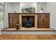 Close-up of the wood burning fireplace in the living room with wooden cabinets and a mantel at 9625 Collins Creek Dr, Chapel Hill, NC 27516