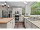Kitchen with stainless steel appliances, granite counters, and tile flooring at 9625 Collins Creek Dr, Chapel Hill, NC 27516