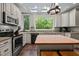 Beautiful kitchen featuring granite countertops, stainless appliances, and center island with bar seating at 9625 Collins Creek Dr, Chapel Hill, NC 27516