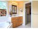 Light-filled bathroom featuring a vanity with a sink, wood cabinets, and a walk-in closet at 101 Cardinal Dr, Youngsville, NC 27596