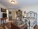 Cozy bedroom showcasing a decorative iron bed frame, hardwood floors, and neutral walls at 101 Cardinal Dr, Youngsville, NC 27596