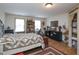 Bright bedroom with decorative quilts, natural light, wood floors, and rustic decor at 101 Cardinal Dr, Youngsville, NC 27596