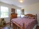 Bright bedroom featuring hardwood floors, a bed with Americana themed decorations, and white walls at 101 Cardinal Dr, Youngsville, NC 27596