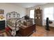 Charming bedroom features a decorative iron bed frame, hardwood floors, and vintage-style decor at 101 Cardinal Dr, Youngsville, NC 27596
