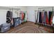 Spacious walk-in closet features carpet, clothing racks, and containers for clothing storage at 101 Cardinal Dr, Youngsville, NC 27596