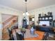 Comfortable dining area with a wooden table, dark chairs, and views into other rooms at 101 Cardinal Dr, Youngsville, NC 27596