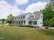 This home boasts a large yard, covered porch, and attached garage at 101 Cardinal Dr, Youngsville, NC 27596