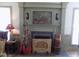 Beautiful fireplace with traditional mantle and hearth and tastefully displayed artwork and holiday decorations at 101 Cardinal Dr, Youngsville, NC 27596