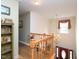 Bright foyer featuring hardwood floors, wooden banister, chandelier, and decoratively adorned walls and shelves at 101 Cardinal Dr, Youngsville, NC 27596