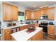 Well-lit kitchen with wood cabinetry, modern appliances, and a functional layout at 101 Cardinal Dr, Youngsville, NC 27596