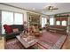 Comfortable living room with decorative fireplace, hardwood floors, natural light, and cozy sofas and chairs at 101 Cardinal Dr, Youngsville, NC 27596