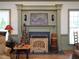 Inviting living room area features a decorative fireplace with green mantle, seasonal decor, and bright natural light at 101 Cardinal Dr, Youngsville, NC 27596
