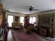 Cozy living room featuring a fireplace, ceiling fan, hardwood floors and plentiful natural light at 101 Cardinal Dr, Youngsville, NC 27596