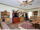 Cozy living room features a mix of wood furniture, natural lighting, and an adjacent dining area at 101 Cardinal Dr, Youngsville, NC 27596