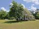 Spacious yard featuring mature trees surrounding a stunning two-story home at 101 Cardinal Dr, Youngsville, NC 27596