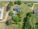 Aerial view showcases the house, detached garage, and surrounding greenery at 10186 W Nc-97 Hwy, Middlesex, NC 27557