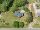Aerial view showcasing the house, detached garage, and surrounding greenery at 10186 W Nc-97 Hwy, Middlesex, NC 27557