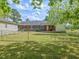 Backyard view of the exterior with a detached garage and grassy lawn at 10186 W Nc-97 Hwy, Middlesex, NC 27557