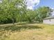 Large backyard with lush lawn and trees, fenced perimeter, and a detached garage at 10186 W Nc-97 Hwy, Middlesex, NC 27557
