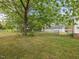 Spacious backyard showing mature trees and detached two-car garage accessible through the chain link fence at 10186 W Nc-97 Hwy, Middlesex, NC 27557