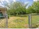 Large backyard with mature trees and a chain link fence offers shade and privacy at 10186 W Nc-97 Hwy, Middlesex, NC 27557
