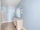 Bathroom with blue walls, vanity, mirror, and built-in lighting, exuding a vintage charm at 10186 W Nc-97 Hwy, Middlesex, NC 27557