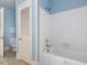 Bathroom featuring a tub, toilet and tilework; door leads to another room at 10186 W Nc-97 Hwy, Middlesex, NC 27557