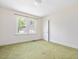 Bright bedroom featuring green carpet and natural light from a window at 10186 W Nc-97 Hwy, Middlesex, NC 27557