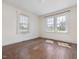 A bedroom with hardwood floors is naturally illuminated by two large windows, creating a serene and inviting space at 10186 W Nc-97 Hwy, Middlesex, NC 27557
