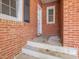 Charming brick exterior showcasing an entryway with steps, a window, and a dark shutter, adding a welcoming touch at 10186 W Nc-97 Hwy, Middlesex, NC 27557