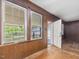 Light filled entryway with wood-paneled walls, multiple windows and exterior access at 10186 W Nc-97 Hwy, Middlesex, NC 27557