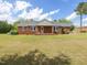 Classic brick home featuring blue shutters and a covered front porch, perfect for enjoying the outdoors at 10186 W Nc-97 Hwy, Middlesex, NC 27557