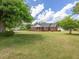 Charming red brick home with a large lawn and blue shutters, exuding classic curb appeal under a blue sky at 10186 W Nc-97 Hwy, Middlesex, NC 27557