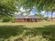 A beautiful red brick home is framed by mature trees, offering a serene and inviting atmosphere at 10186 W Nc-97 Hwy, Middlesex, NC 27557