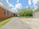 The exterior of the red brick home with a long driveway and a detached garage at 10186 W Nc-97 Hwy, Middlesex, NC 27557