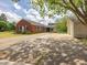 View of the red brick home with a long driveway and a detached garage at 10186 W Nc-97 Hwy, Middlesex, NC 27557