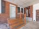 Charming front porch with brick facade, wooden steps, and a covered entrance at 10186 W Nc-97 Hwy, Middlesex, NC 27557
