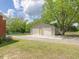 Exterior shot of two-car garage, including a two-car garage door and a separate entry door at 10186 W Nc-97 Hwy, Middlesex, NC 27557