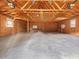 Unfinished two-car garage with vaulted ceilings and overhead lighting, ideal for conversion at 10186 W Nc-97 Hwy, Middlesex, NC 27557